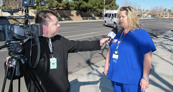 Michelle Swett speaks to Time Warner Cable in front of Kaiser Lancaster